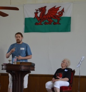 Nic Schumer regales the congregation with a history in the crucial role that churches played in preserving Welsh culture, as Carol Ellis, Gamanfa Ganu leader, looks on.